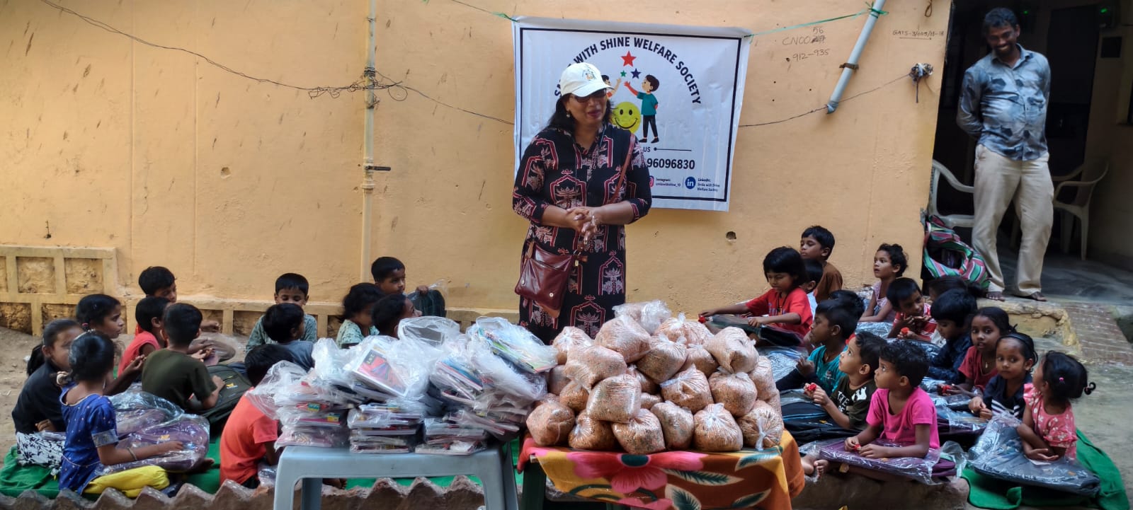 A child smiling after receiving notebooks and stationery