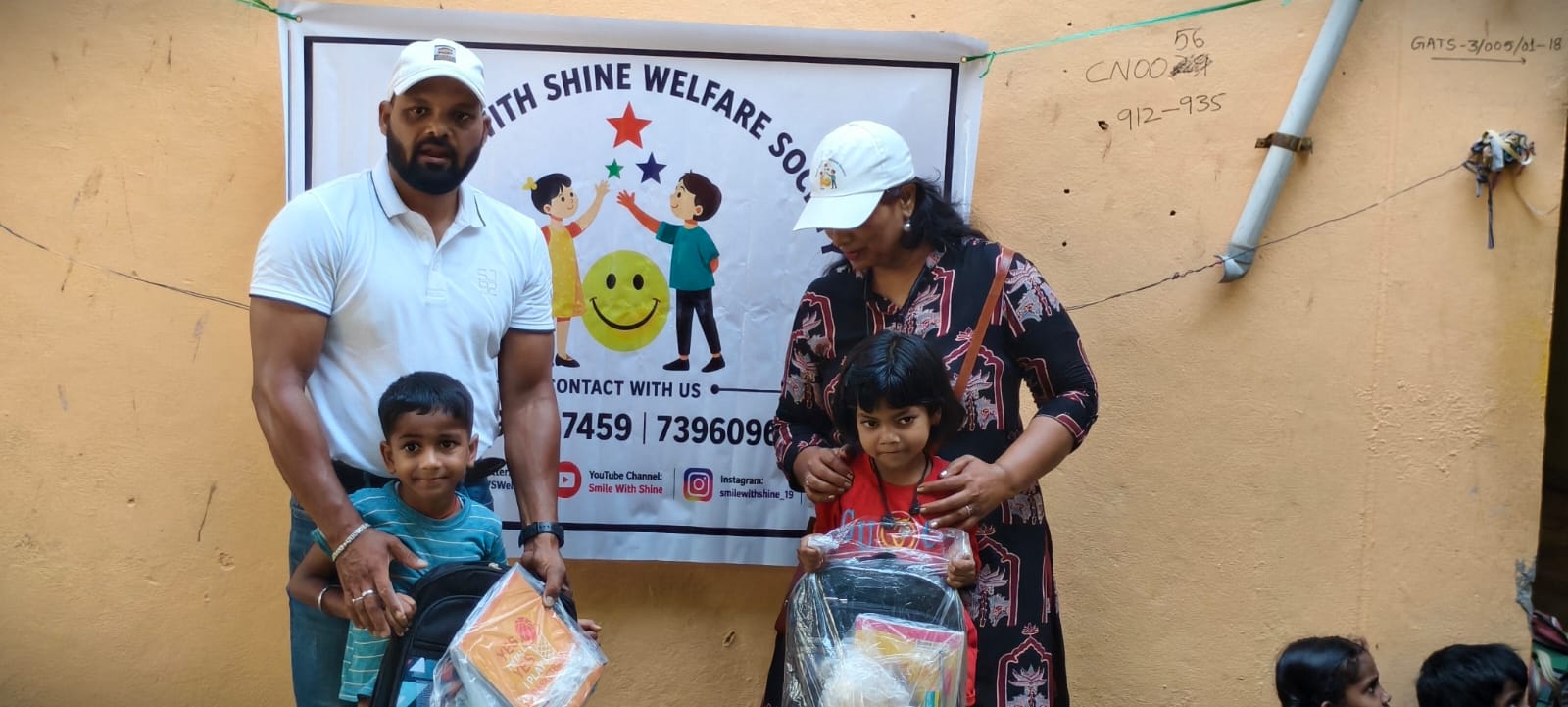 A child receiving a free school bag and notebooks from Smile With Shine