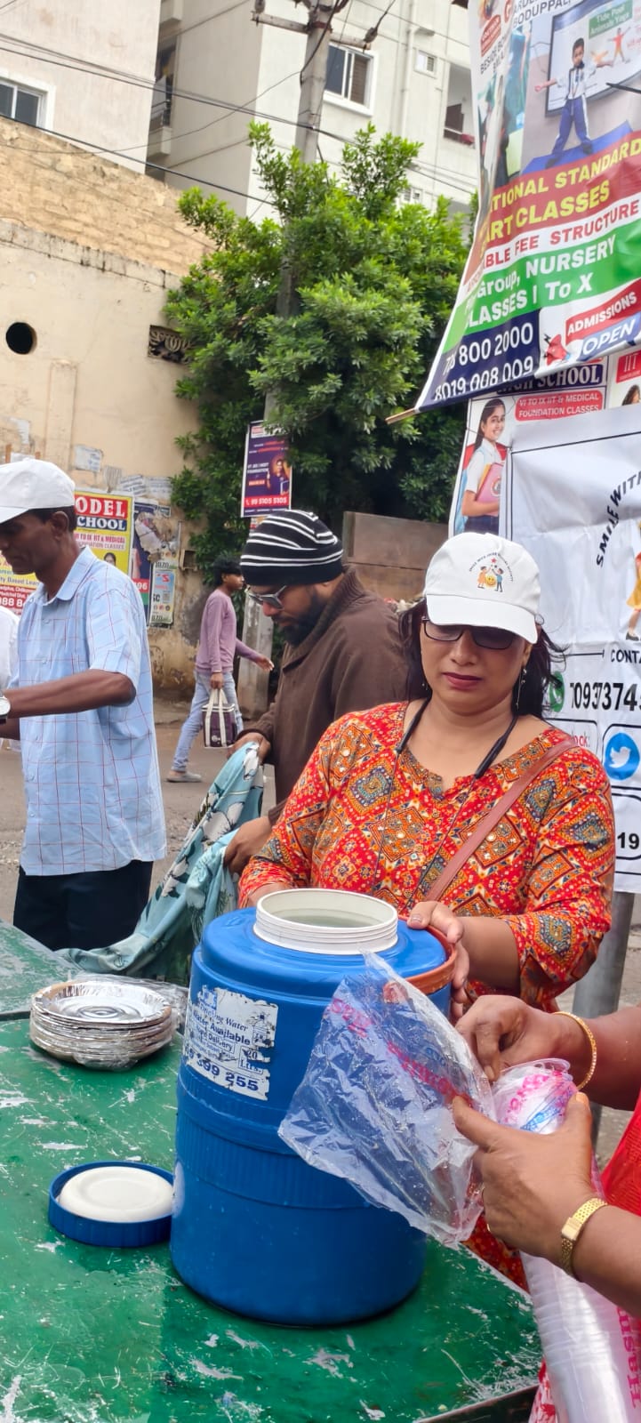 Warm breakfast plate being handed over with drinking water