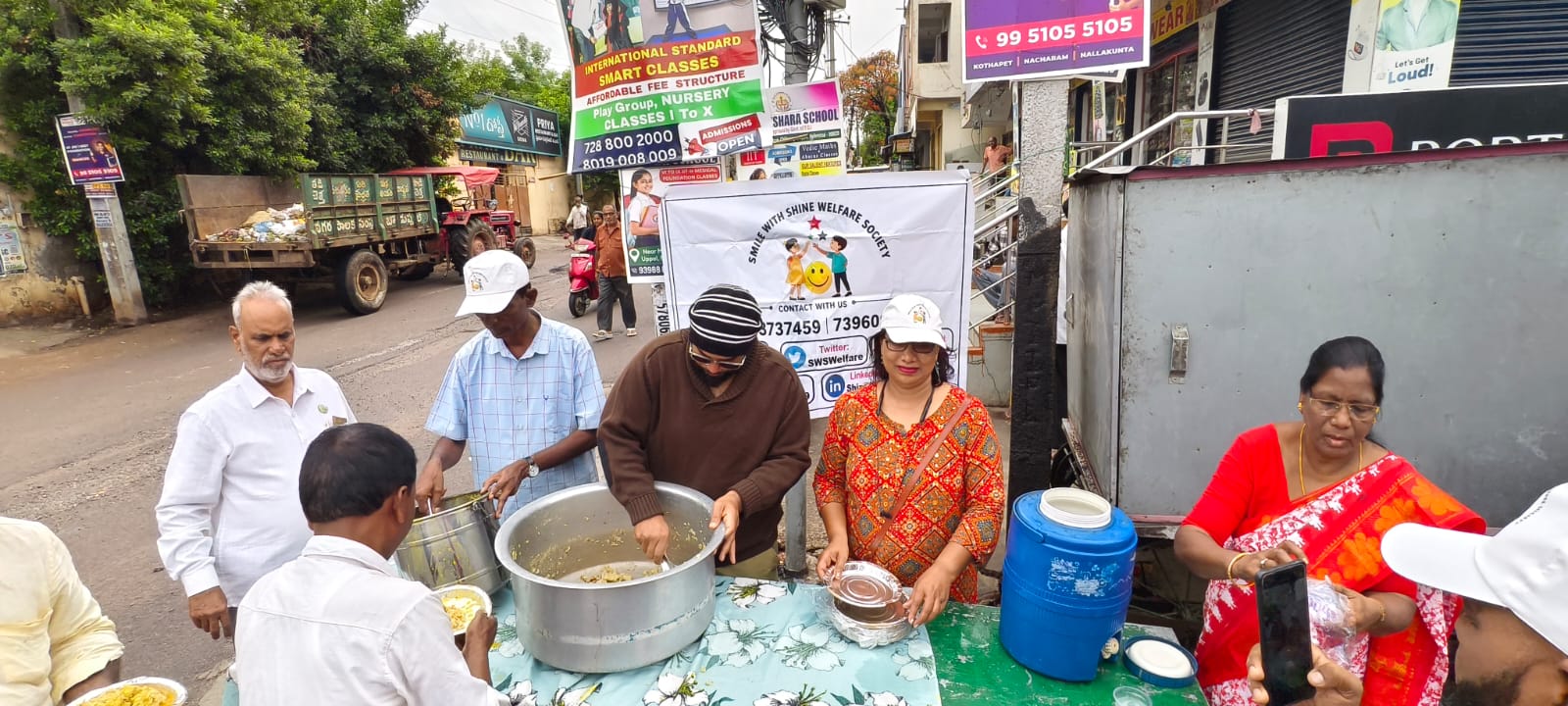 A person receiving a warm breakfast plate by hand on a Hyderabad street