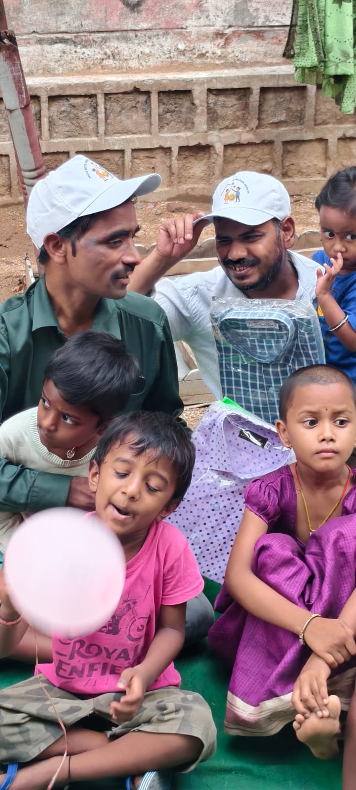 Smile With Shine team distributing shirts and caps to fathers on Father's Day