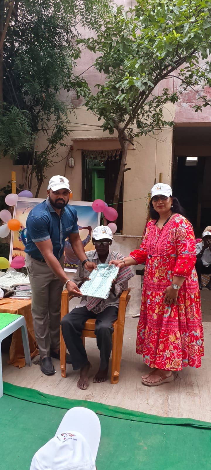 A father receiving a new shirt at the Father's Day celebration in Hyderabad