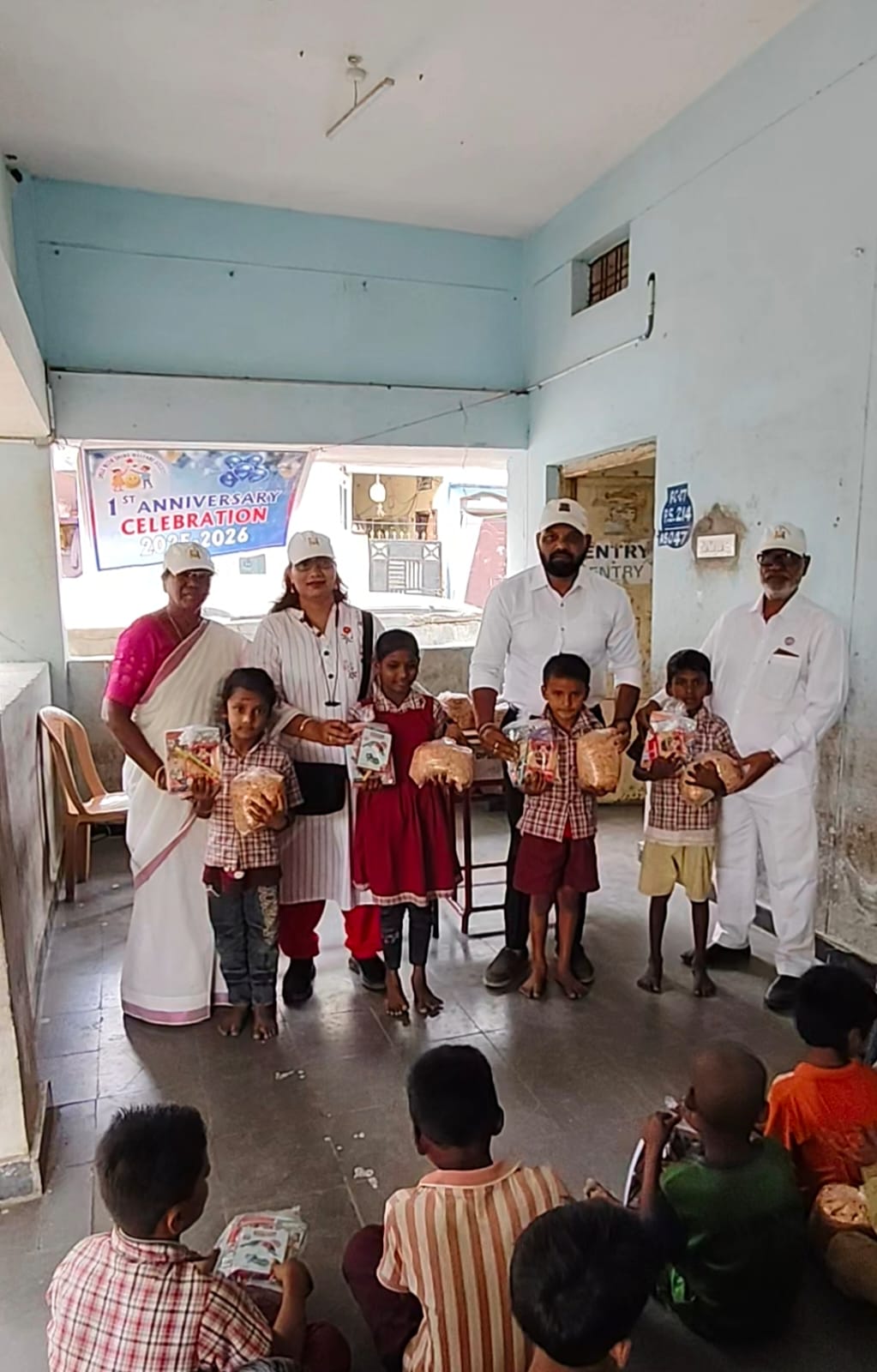 The senior Smile With Shine team distributing kits and food packs to primary school children