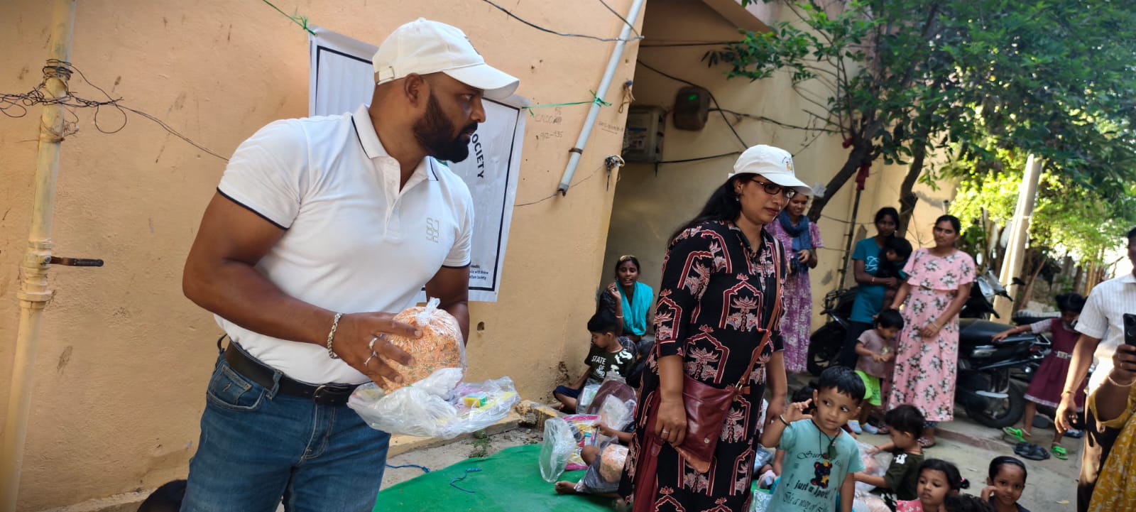 Grace Mani handing kit to child