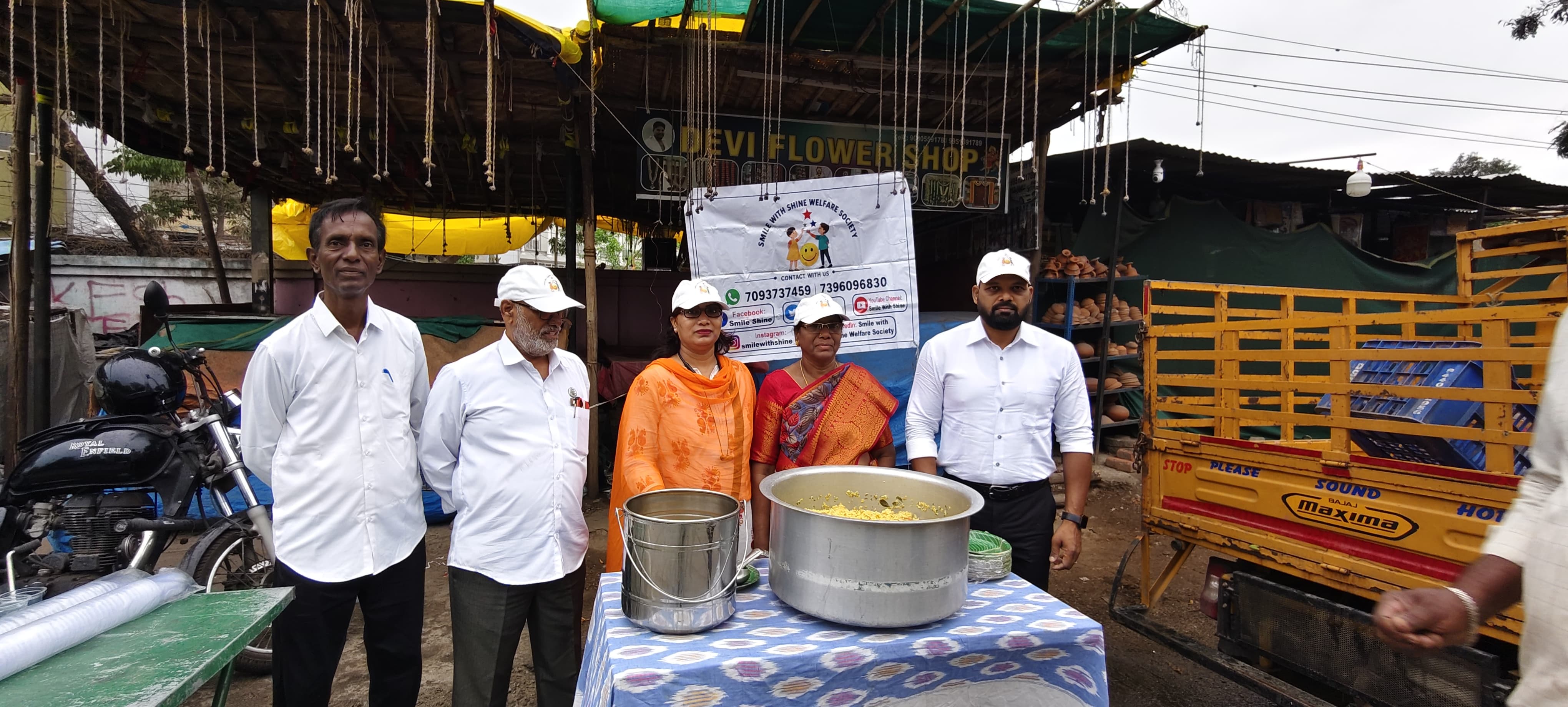 Smile With Shine Welfare Society team set up on a Hyderabad roadside with the SWS banner and hot food containers, ready to serve the Tuesday, July 21, 2026 Roadside Breakfast Drive